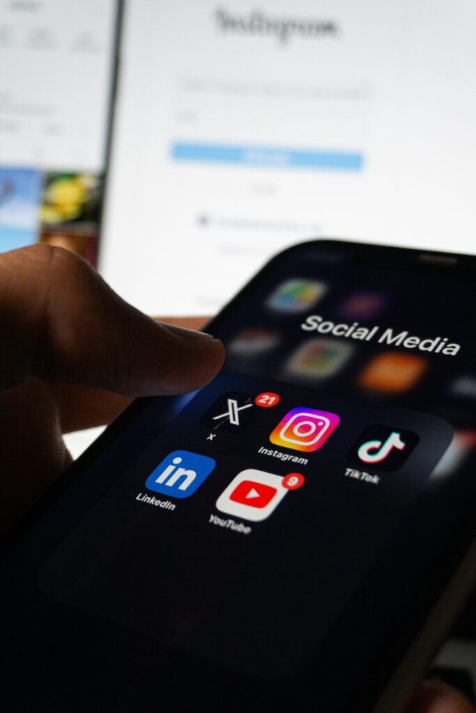 A phone screen showing popular social media app icons, such as Twitter, Instagram, and TikTok. Provided by Unsplash.